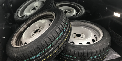 steel wheels with new tyres in the back of a car