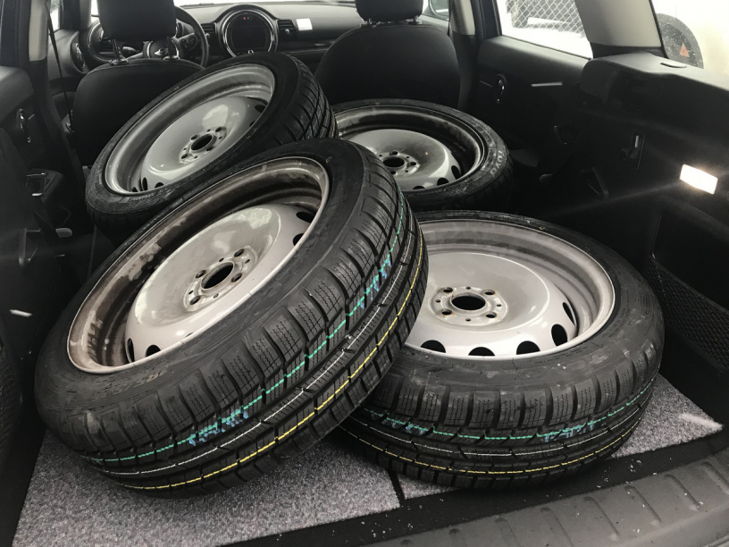 steel wheels with new tyres in the back of a car