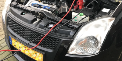 image of swift with battery connected to another car for charging