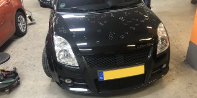 image of a suzuki swift bonnet with 100 white marking for identified dents