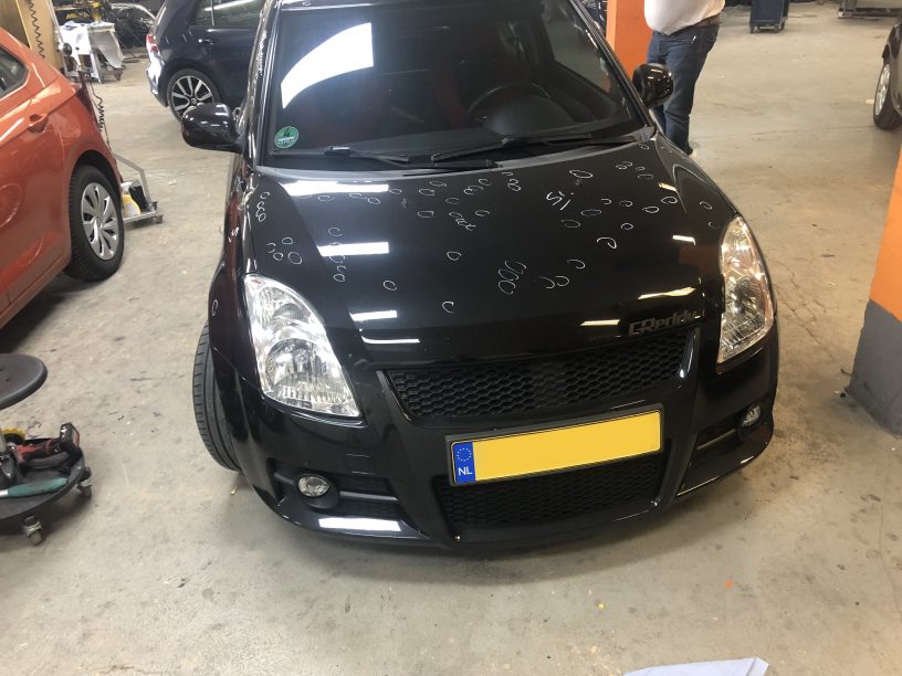 image of a suzuki swift bonnet with 100 white marking for identified dents